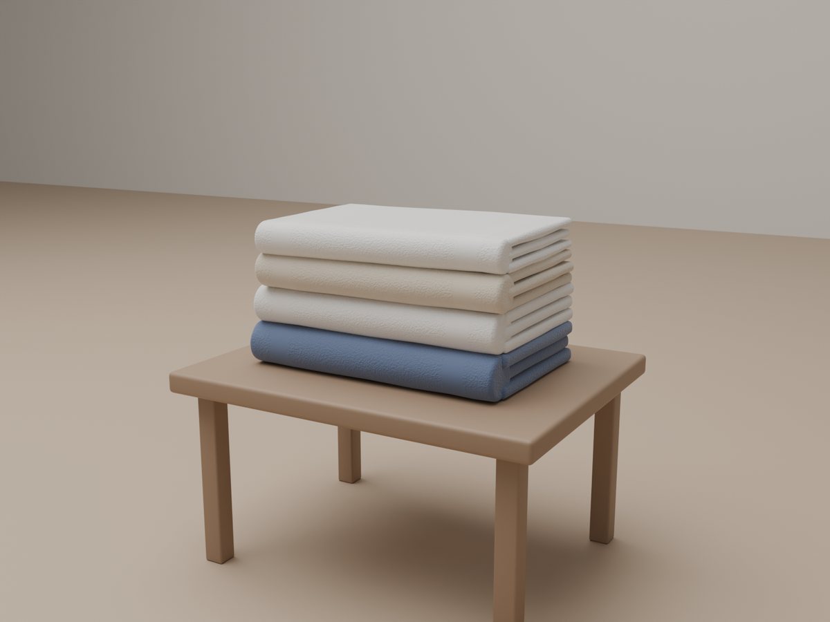 Folded towels in white, cream and blue on a small wooden table